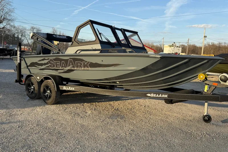 Slide: The Image of 2026 SeaArk ProCat 200 boat on trailer, parked outdoors under clear sky. - 5