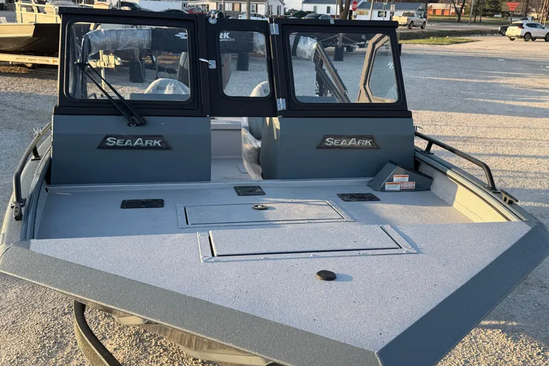 Slide: The Image of 2026 SeaArk ProCat 200 boat with dual windshields, parked outdoors. - 9