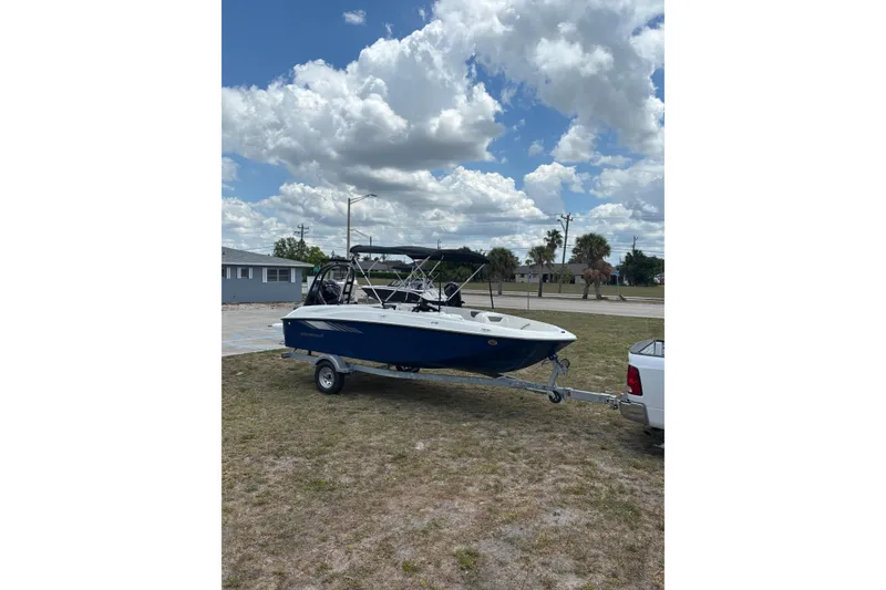 Slide: The Image of 2026 Bayliner Element E18 boat on trailer under cloudy sky. - 4