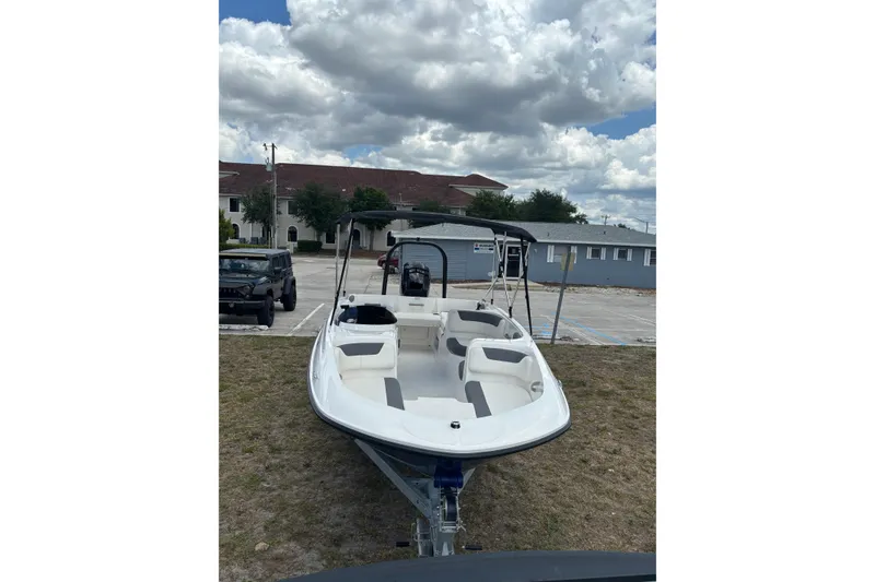 Slide: The Image of 2026 Bayliner Element E18 boat parked outdoors under a cloudy sky. - 5