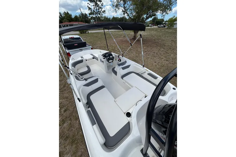 Slide: The Image of 2026 Bayliner Element E18 boat with spacious seating and sleek design, parked outdoors. - 8