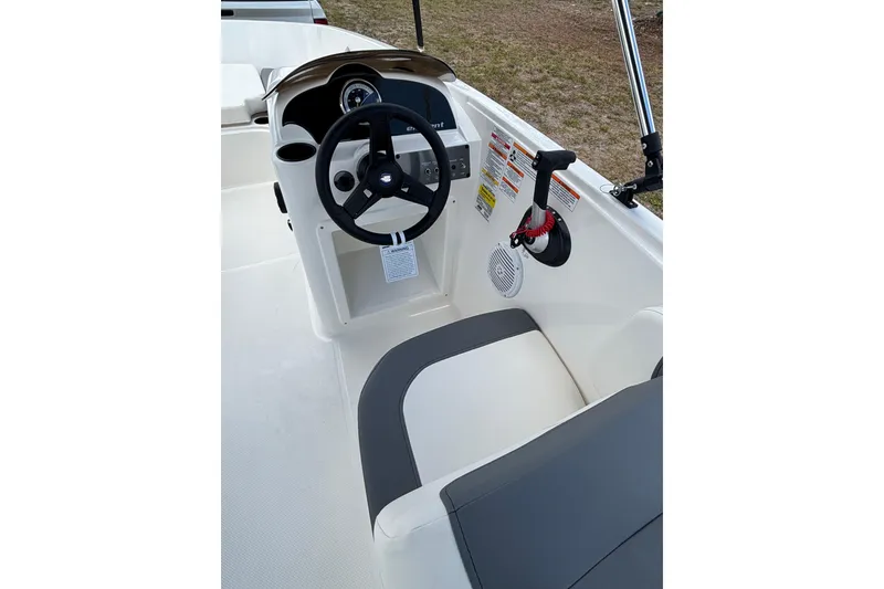 Slide: The Image of 2026 Bayliner Element E18 boat cockpit with steering wheel and seating. - 9