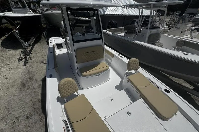 Slide: The Image of 2026 Sportsman Masters 247 Bay Boat with tan seating, docked outdoors. - 12