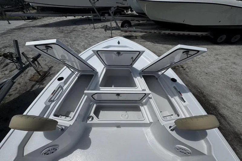 Slide: The Image of 2026 Sportsman Masters 247 Bay Boat with open storage compartments, showcasing spacious deck layout. - 16