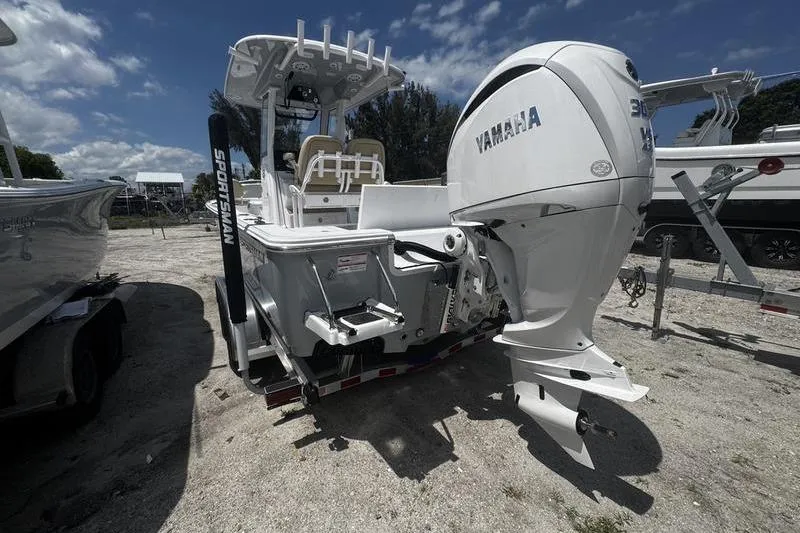 Slide: The Image of 2026 Sportsman Masters 247 Bay Boat with Yamaha engine, parked on gravel lot. - 17