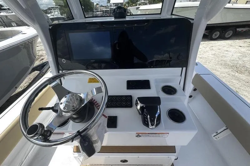 Slide: The Image of Helm of 2026 Sportsman Masters 247 Bay Boat with steering wheel and controls. - 23