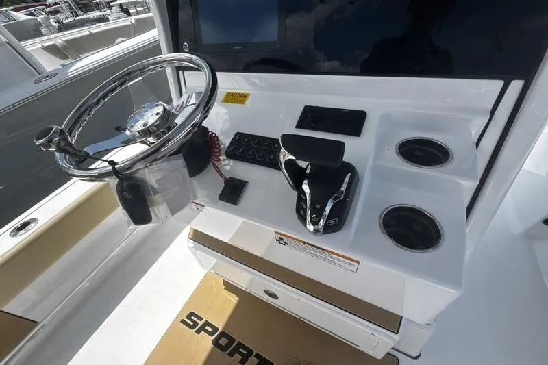 Slide: The Image of 2026 Sportsman Masters 247 Bay Boat helm with steering wheel and controls. - 25