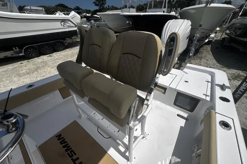 Slide: The Image of 2026 Sportsman Masters 247 Bay Boat interior with beige seating and console. - 26