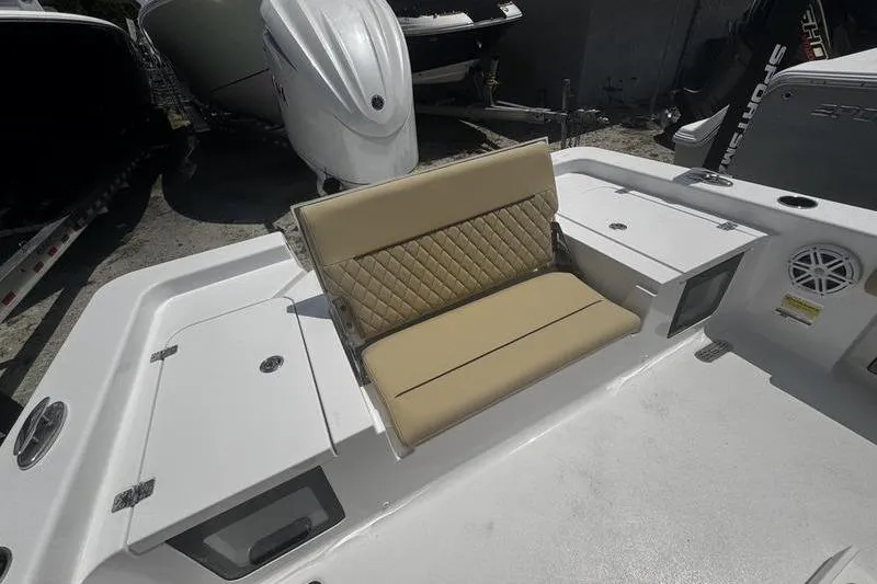 Slide: The Image of 2026 Sportsman Masters 247 Bay Boat with tan seating and storage compartments. - 28