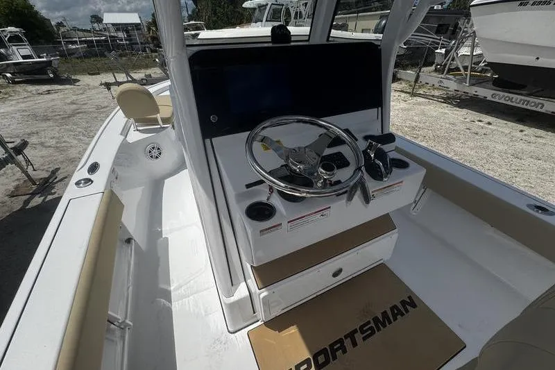 Slide: The Image of 2026 Sportsman Masters 247 Bay Boat interior with steering console and seating. - 3