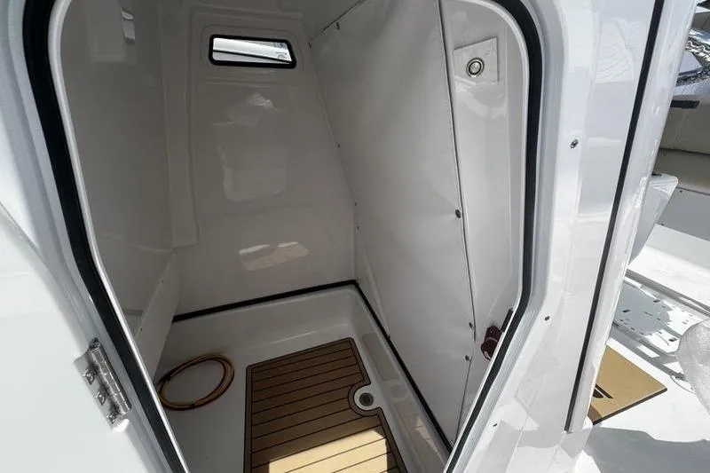 Slide: The Image of Interior cabin of 2026 Sportsman Masters 247 Bay Boat, featuring sleek design and wood flooring. - 8