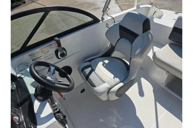 Slide: The Image of 2020 Hurricane SunDeck 187 OB boat interior with steering wheel and captain's chair. - 11