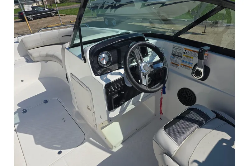 Slide: The Image of 2020 Hurricane SunDeck 187 OB boat interior with steering wheel and seating area. - 12