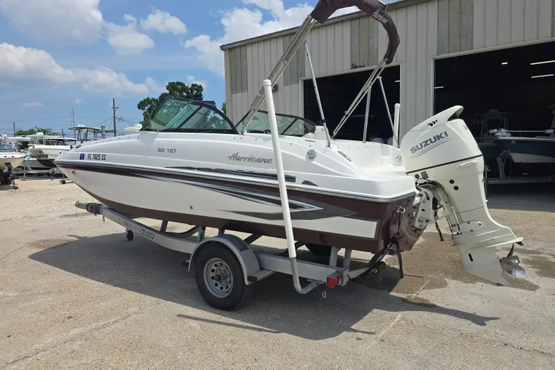 Slide: The Image of 2020 Hurricane SunDeck 187 OB boat with Suzuki outboard motor on trailer. - 4