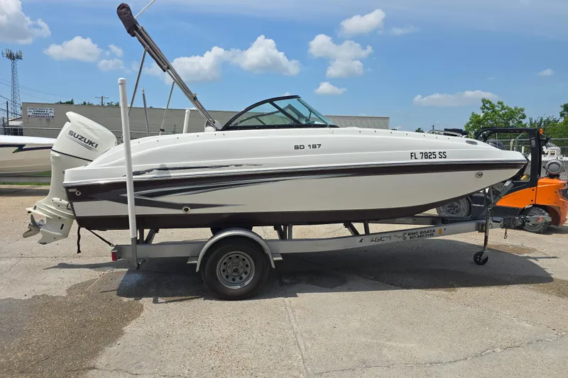 Slide: The Image of 2020 Hurricane SunDeck 187 OB boat on trailer, featuring Suzuki outboard motor. - 5