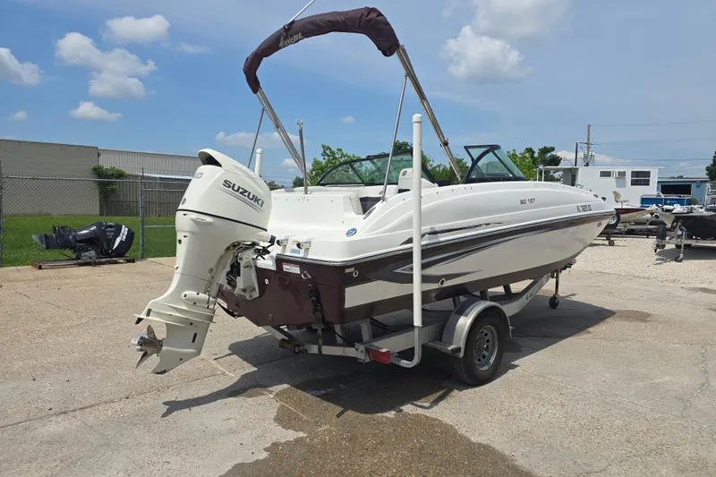 Slide: The Image of 2020 Hurricane SunDeck 187 OB boat with Suzuki outboard motor on trailer. - 7