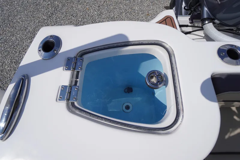 Slide: The Image of Livewell on 2023 Tidewater 232 CC Adventure boat, featuring stainless steel fittings. - 13