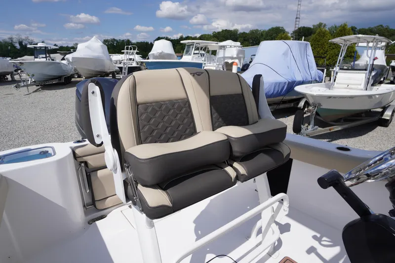Slide: The Image of 2023 Tidewater 232 CC Adventure boat seats in a marina setting. - 15