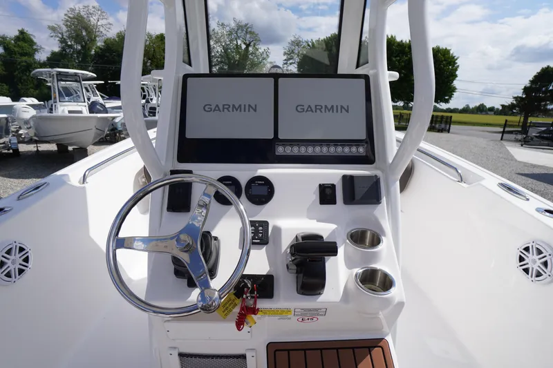Slide: The Image of 2023 Tidewater 232 CC Adventure boat dashboard with Garmin displays and steering wheel. - 21
