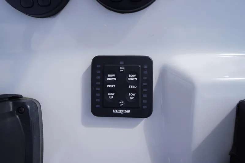Slide: The Image of Control panel on 2023 Tidewater 232 CC Adventure boat, featuring Lectrotab trim tab switches. - 27