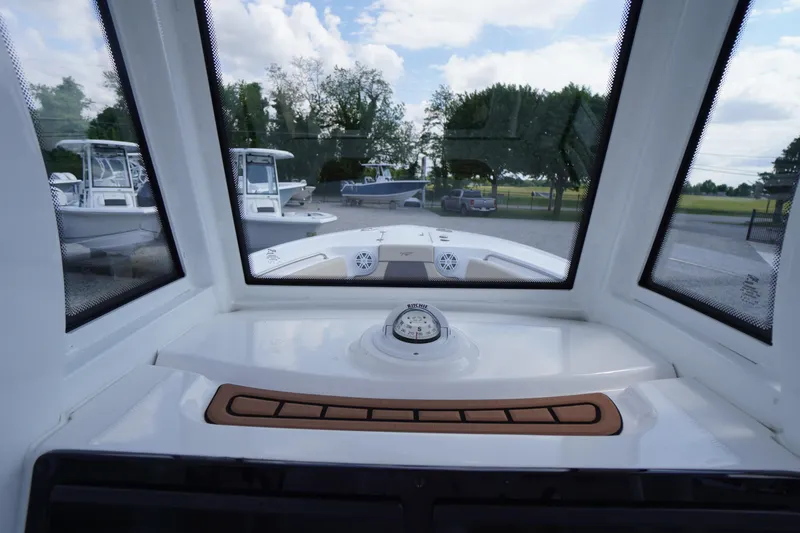 Slide: The Image of Interior view of 2023 Tidewater 232 CC Adventure boat, showcasing dashboard and compass. - 29