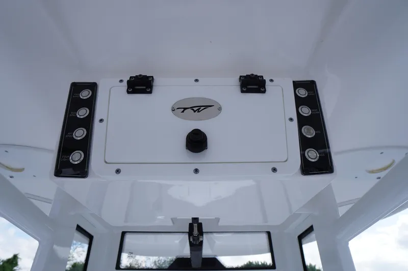 Slide: The Image of 2023 Tidewater 232 CC Adventure boat console with control panel and logo. - 31
