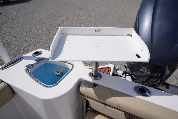 Slide: The Image of 2023 Tidewater 232 CC Adventure boat with a cutting board and livewell setup. - 32