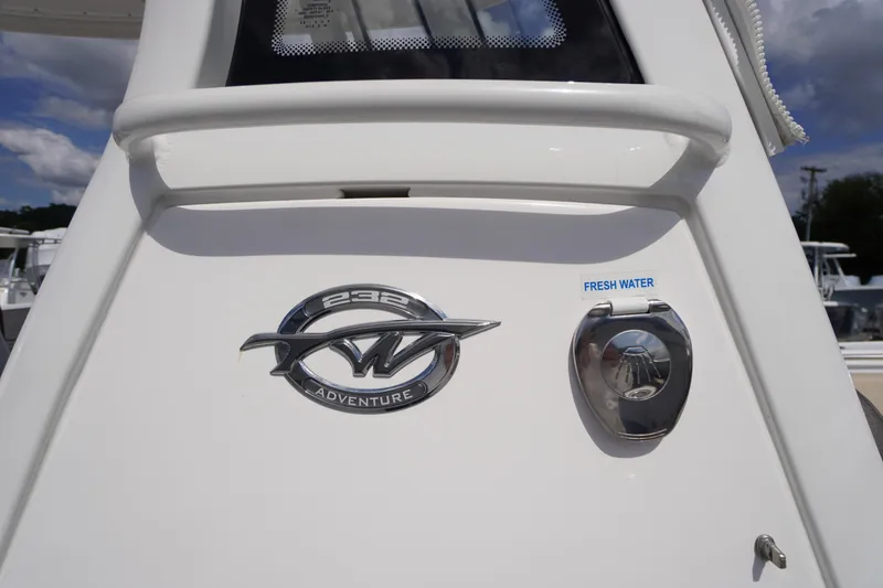 Slide: The Image of 2023 Tidewater 232 CC Adventure boat emblem and fresh water access. - 33