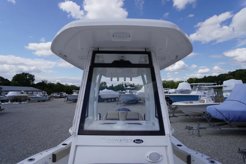 Slide: The Image of 2023 Tidewater 232 CC Adventure boat in a marina, surrounded by other vessels. - 34