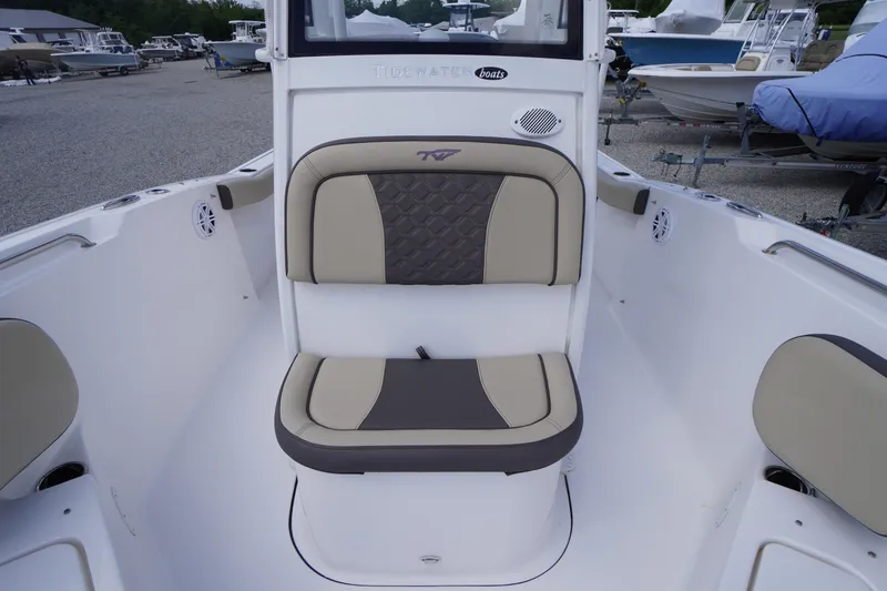 Slide: The Image of 2023 Tidewater 232 CC Adventure boat interior with cushioned seating and modern design. - 35