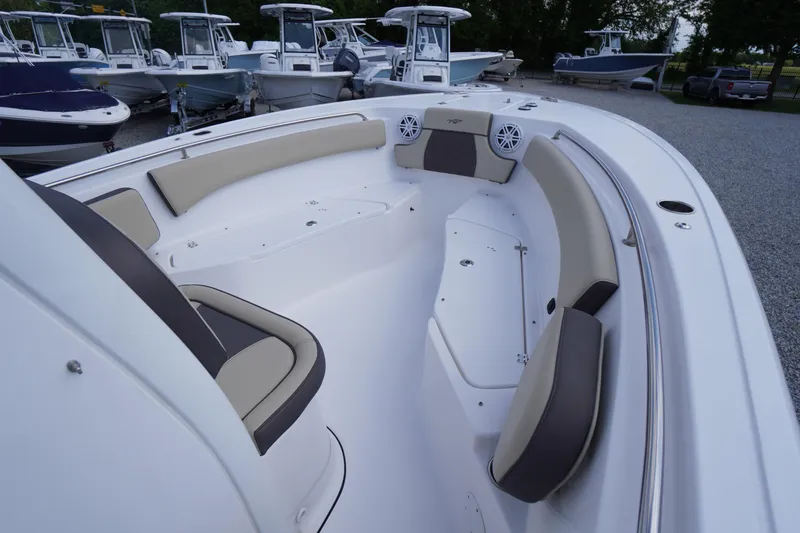 Slide: The Image of 2023 Tidewater 232 CC Adventure boat interior with cushioned seating and modern design. - 36