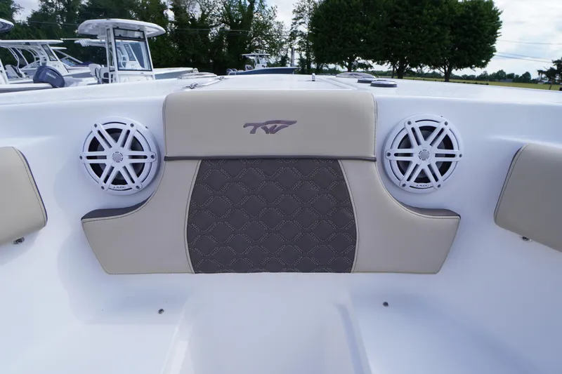 Slide: The Image of 2023 Tidewater 232 CC Adventure boat interior with speakers and cushioned seating. - 37