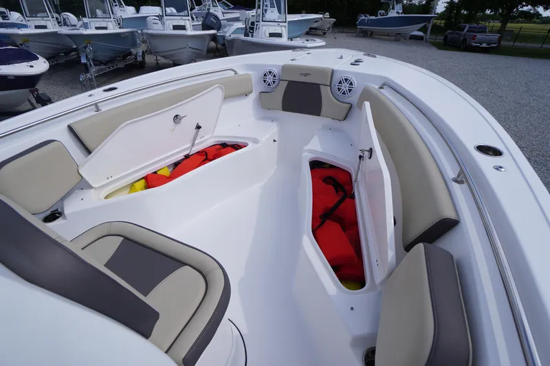 Slide: The Image of 2023 Tidewater 232 CC Adventure boat interior with open storage compartments and seating. - 40