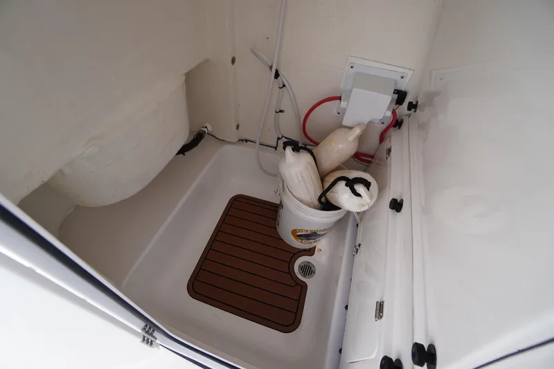 Slide: The Image of Storage compartment of 2023 Tidewater 232 CC Adventure boat with safety equipment. - 44