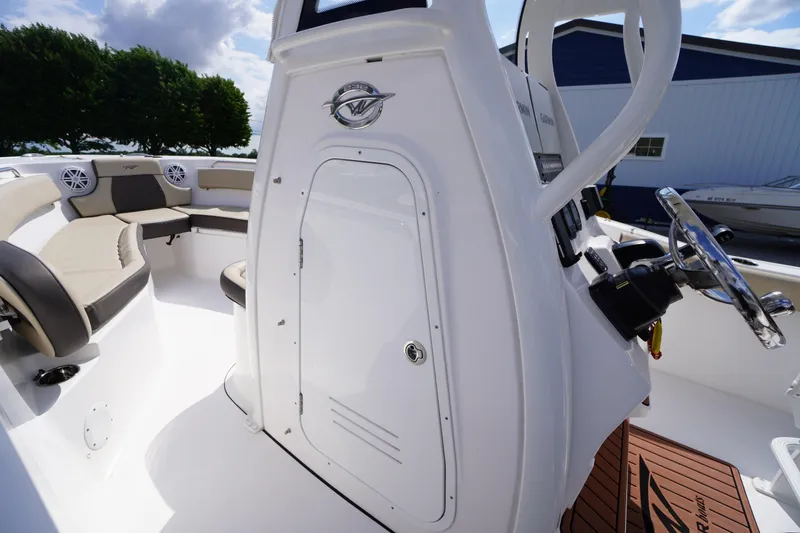 Slide: The Image of 2023 Tidewater 232 CC Adventure boat interior with seating and steering console. - 45