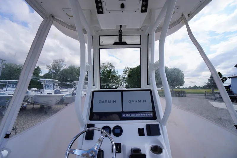 Slide: The Image of 2023 Tidewater 232 CC Adventure boat cockpit with dual Garmin displays and steering wheel. - 46