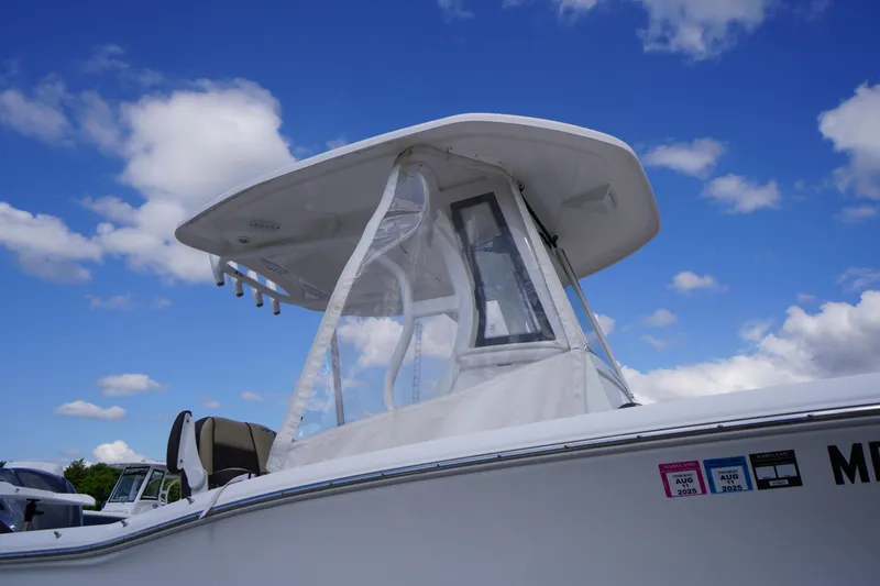 Slide: The Image of 2023 Tidewater 232 CC Adventure boat under a clear blue sky. - 47