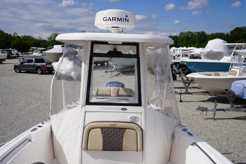 Slide: The Image of 2023 Tidewater 232 CC Adventure boat with Garmin equipment, displayed outdoors on gravel lot. - 48