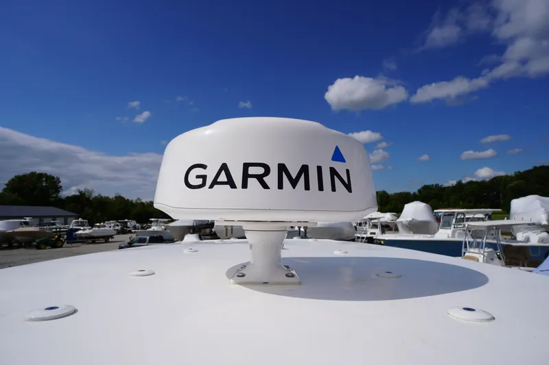 Slide: The Image of Garmin radar on 2023 Tidewater 232 CC Adventure boat under blue sky. - 50