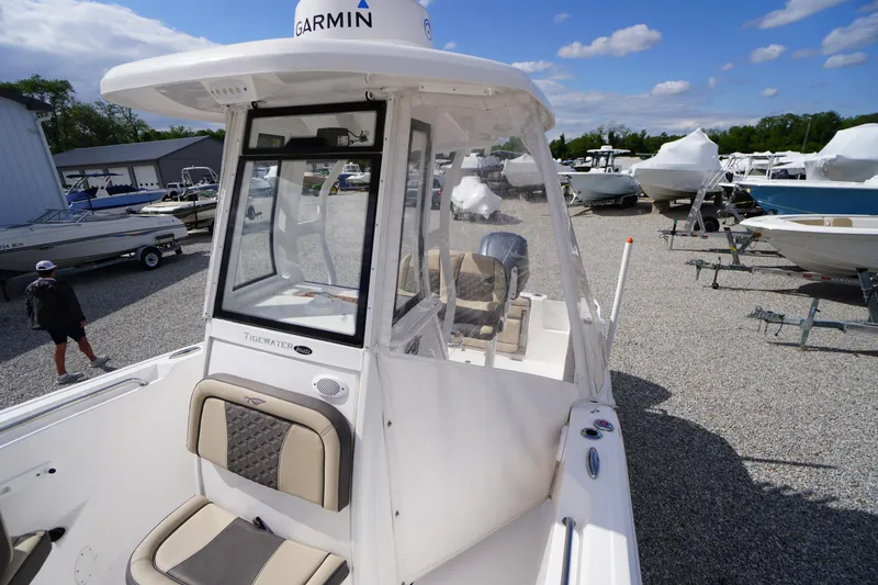 Slide: The Image of 2023 Tidewater 232 CC Adventure boat in a marina, featuring Garmin equipment. - 51