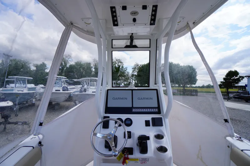 Slide: The Image of 2023 Tidewater 232 CC Adventure boat cockpit with Garmin navigation displays. - 52