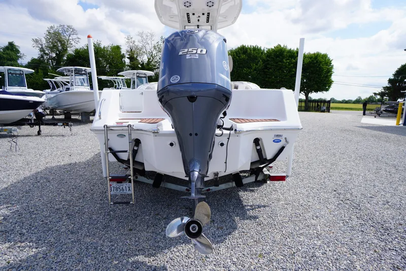 Slide: The Image of 2023 Tidewater 232 CC Adventure boat with powerful outboard motor, displayed on gravel lot. - 7