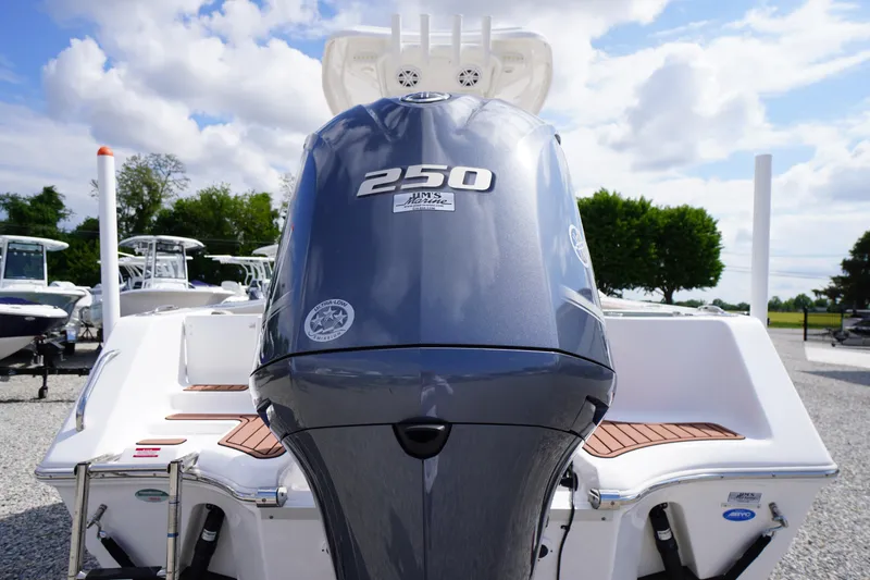 Slide: The Image of 2023 Tidewater 232 CC Adventure boat with powerful 250 HP engine, displayed outdoors. - 8