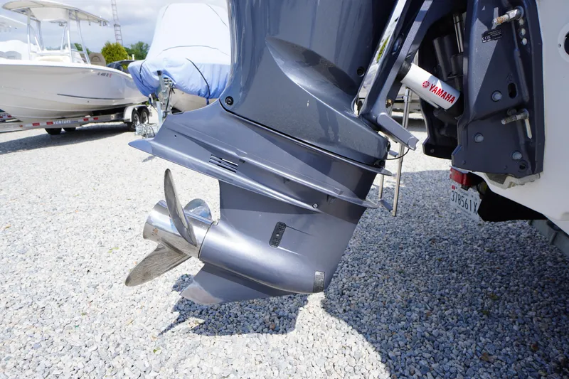 Slide: The Image of 2023 Tidewater 232 CC Adventure boat with Yamaha outboard motor on gravel lot. - 9