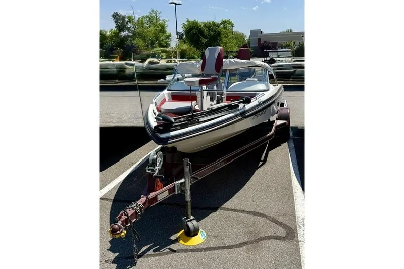 The Image of 1996 Astro 18 FSX boat on trailer in parking lot, sunny day. - 1