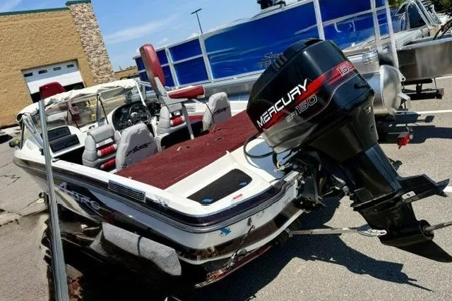 Slide: The Image of 1996 Astro 18 FSX boat with Mercury 150 outboard motor, parked outdoors. - 3