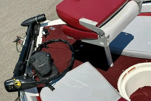 Slide: The Image of 1996 Astro 18 FSX boat interior with red and white seating and trolling motor. - 5