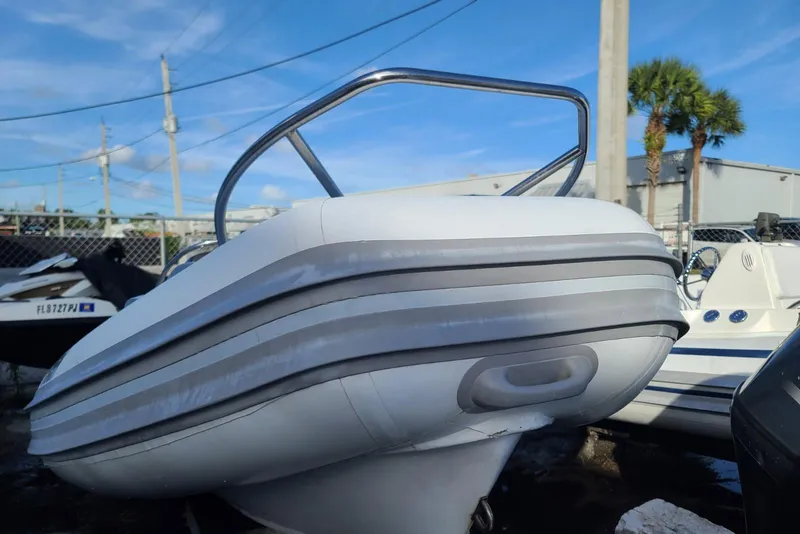 Slide: The Image of 2009 Nautica 15 DL boat with sleek design, parked outdoors under blue sky. - 3