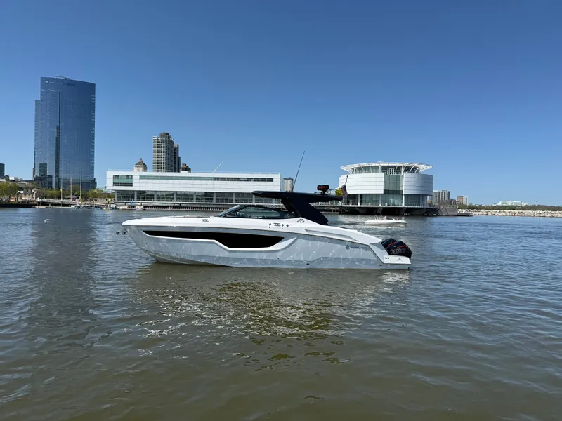 Slide: The Image of 2021 Cruisers Yachts 38 GLS on a calm urban waterway. - 14