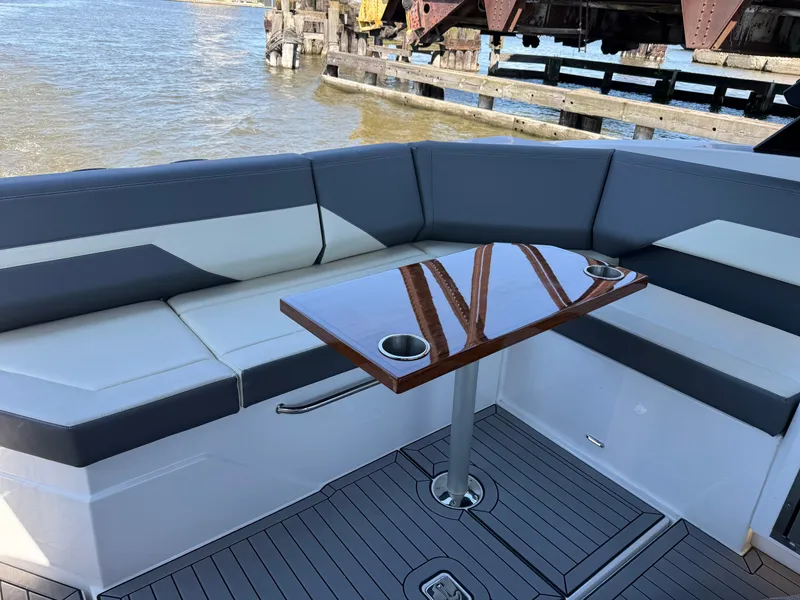 Slide: The Image of Interior of 2021 Cruisers Yachts 38 GLS with sleek seating and wooden table. - 22